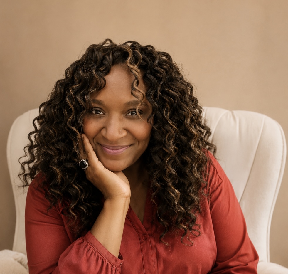 Octavia Dosier smiling with her hand resting against her face